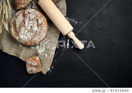 Freshly baked bread on dark kitchen table, top view 91411940
