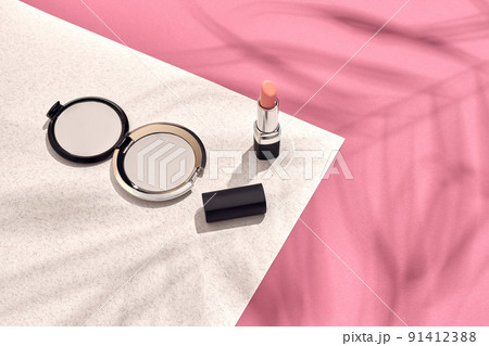 Fashionable Women's Cosmetics and Accessories. Flat Lay. Pink and white background. Shadow from a palm leaf Fashionable Women's Cosmetics and Accessories. Flat Lay. Pink and white background. Shadow from a palm leaf 91412388
