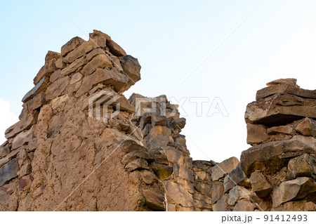 ruins of ancient stone walls against a cloudy sky ruins of ancient stone walls against a cloudy sky 91412493
