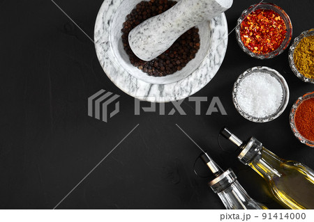 Various spices and mortar on black background with copy space Various spices and mortar on black background with copy space 91414000