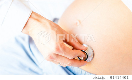 Pregnant doctor hospital. Medical clinic for pregnancy consultant. Doctor examining pregnancy woman belly holding stethoscope. Pregnancy, medicine health care concept. Pregnant doctor hospital. Medical clinic for pregnancy consultant. Doctor examining pregnancy woman belly holding stethoscope. Pregnancy, medicine health care concept. 91414401