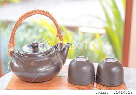 hand pour Chinese or Japanese traditional tea from clay pot hand pour Chinese or Japanese traditional tea from clay pot 91414515