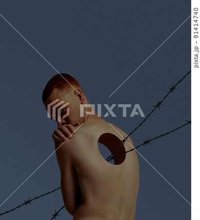 Contemporary art collage. Conceptual image with young man and hole into body with sharp wire coming through. Torn inner world 91414740