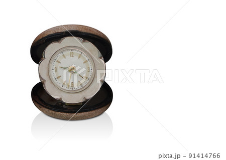 front view antique alarm clock in a brown leather circle box on white background, gift, old, ancient, modern, vintage, decor, copy space 91414766