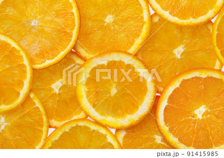Many orange round slices top view. Orange citrus fruits background. 91415985