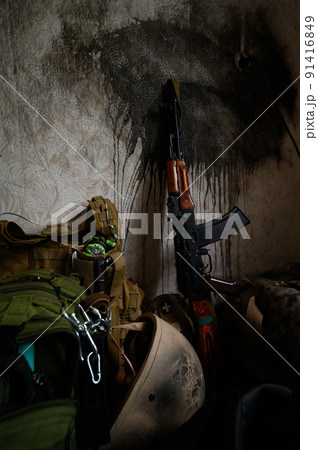 The Ukrainian soldier's machine gun is leaning against the wall in the house, the war in Ukraine. The Ukrainian soldier's machine gun is leaning against the wall in the house, the war in Ukraine. 91416849