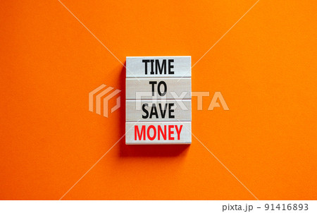 Time to save money symbol. Concept words Time to save money on wooden blocks on a beautiful orange table orange background. Business, finacial and time to save money concept. Time to save money symbol. Concept words Time to save money on wooden blocks on a beautiful orange table orange background. Business, finacial and time to save money concept. 91416893