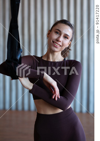 Fit woman standing in the gym with trx Fit woman standing in the gym with trx 91417220