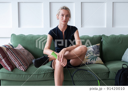 Portrait of a young woman tennis player at home 91420010