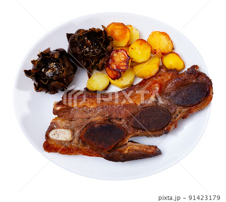 Grilled veal ribs churrasco with fried potatoes and artichokes Grilled veal ribs churrasco with fried potatoes and artichokes 91423179