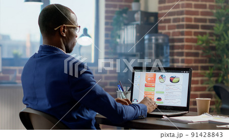 Company employee analyzing business information on laptop to create online presentation. Office worker using executive research statistics, planning startup project on website browser app. 91428843