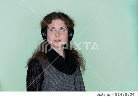 Close up portrait of pensive woman in headphones 91428904