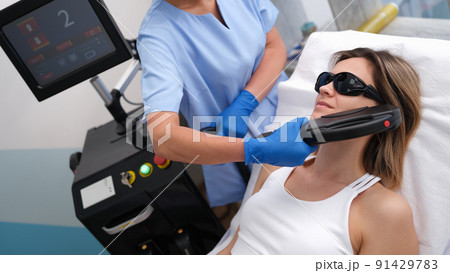 Elos epilation hair removal procedure on woman face Elos epilation hair removal procedure on woman face 91429783