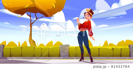 Woman in autumn city park waving hand on street 91433764