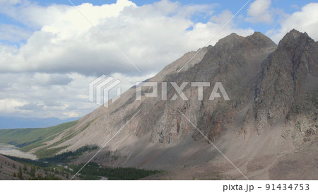 Mountains of Aktru valley with river and forest under white clouds in Altai 91434753