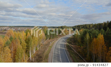 Asphalt road with traffic cars between forest in Ural 91434827