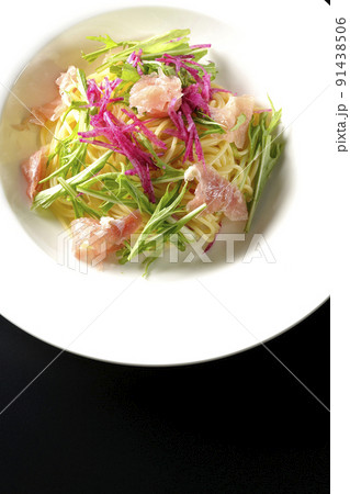 赤大根や水菜、生ハム、カッペリーニを使用した冷製パスタを黒背景で俯瞰撮影 91438506