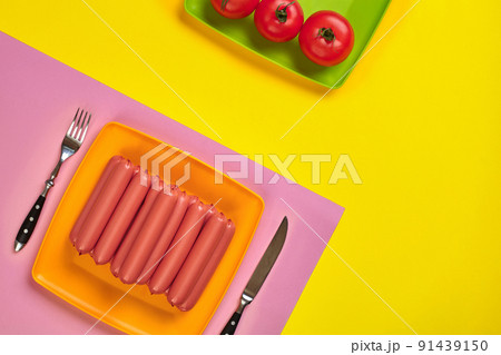 Sausages on a yellow and pink minimal background. Flat lay. Top view. 91439150
