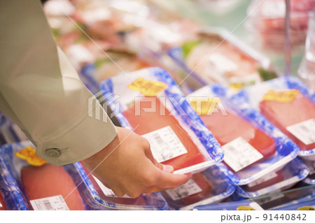 スーパーでまぐろのさくを手に取る作業員男性 91440842