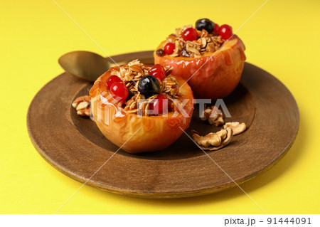 Concept of tasty food with baked apple on yellow background 91444091