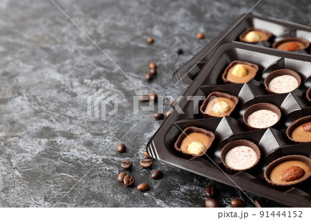 Concept of sweets with chocolate candies on dark textured background 91444152