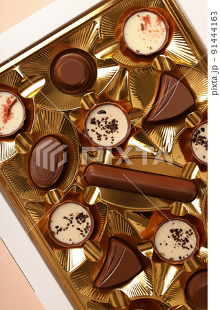 Concept of sweets with chocolate candies on beige background 91444163