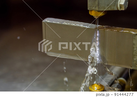 Wire cutting machine working with metal workpiece with sparks at factory 91444277