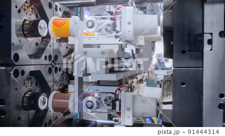 Production of empty plastic cups - injection molding machine during work 91444314