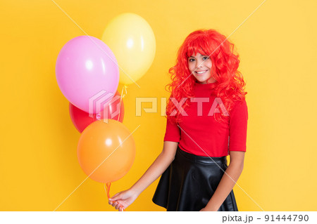 child smile with party balloon on yellow background child smile with party balloon on yellow background 91444790