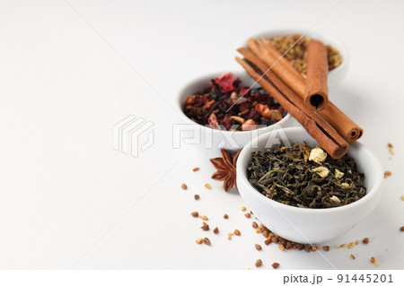 Concept of cooking tea with different types of tea on white background Concept of cooking tea with different types of tea on white background 91445201