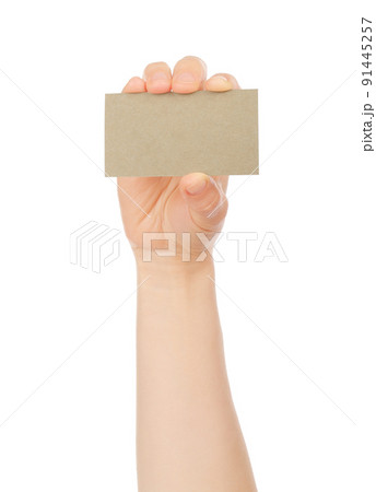 Hand holds blank business card on white background Hand holds blank business card on white background 91445257