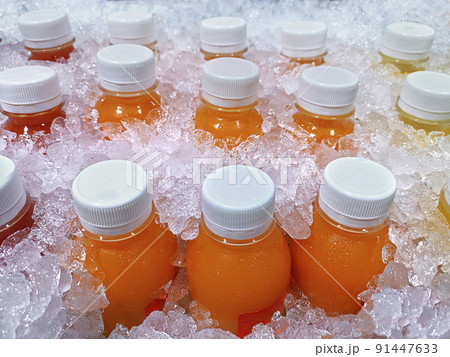 Bottles of fresh fruit juices in the ice bucket, which are orange juice, passion fruit juice, pineapple juice Bottles of fresh fruit juices in the ice bucket, which are orange juice, passion fruit juice, pineapple juice 91447633