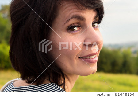 Close-up portrait of a woman 40-44 years old with short black hair 91448154