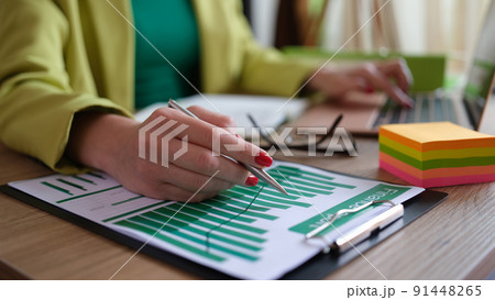 Business woman working with documents at the table in office closeup Business woman working with documents at the table in office closeup 91448265