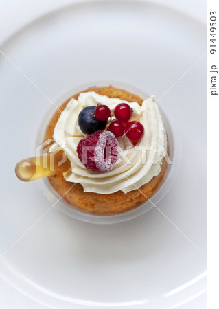 Red fruits rum and Chantilly cream on a delicious cake 91449503