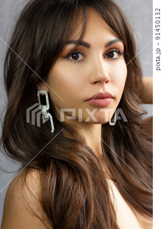 Close-up portrait of beautiful woman's purity face with dark green smoky-eyes make-up, pale full lips. Sexy model with clean shiny skin, purity complexion 91450132