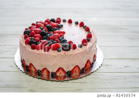 Home made cake with berries. Cake with Strawberry, blackberry, blueberry, and raspberry on a table Home made cake with berries. Cake with Strawberry, blackberry, blueberry, and raspberry on a table 91450574