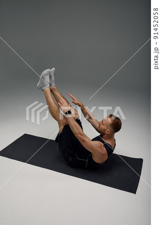 Male Morning Workout. Sporty Man Doing Sit-Ups Abs Exercise On Gymnastics Mat Training And Working Out. Fitness Lifestyle Motivation, Stay Fit Concept Male Morning Workout. Sporty Man Doing Sit-Ups Abs Exercise On Gymnastics Mat Training And Working Out. Fitness Lifestyle Motivation, Stay Fit Concept 91452058