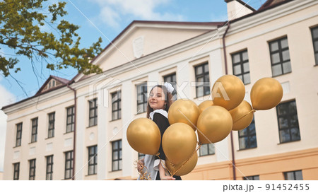 Happy Russian schoolgirl on the last day of school with balloons. 91452455