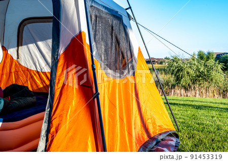 Assembled camping tent with anchor string and open flap 91453319