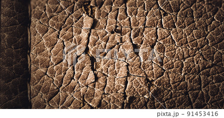 Focus stack macro of cracked faux leather on furniture with visible damage. Focus stack macro of cracked faux leather on furniture with visible damage. 91453416
