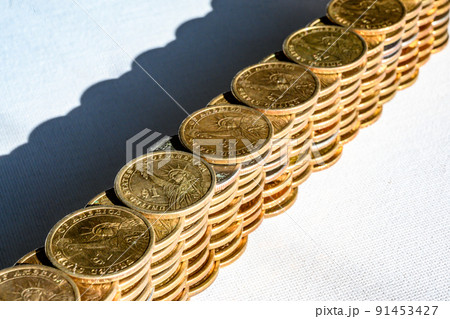 Stack of gold and silver dollar coins forming a border wall Stack of gold and silver dollar coins forming a border wall 91453427
