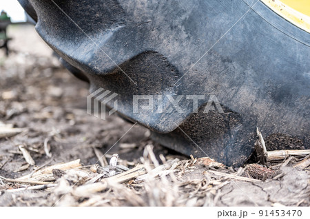 Soil compaction caused by a large tractor tire over topsoil dirt in an empty field before planting. Soil compaction caused by a large tractor tire over topsoil dirt in an empty field before planting. 91453470