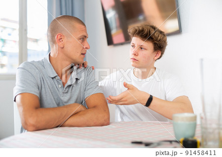 Portrait of guy with his father who are resting together at home 91458411