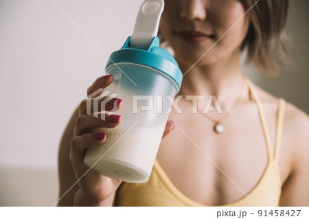 プロテインを飲む若い女性 91458427