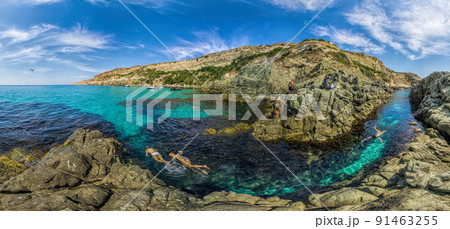 girls dive on Baunty beach, cape Fiolent in Sevastopol, Crimea on a background of rocky shores. The concept of an travel, relax, active and healthy life in harmony with nature. girls dive on Baunty beach, cape Fiolent in Sevastopol, Crimea on a background of rocky shores. The concept of an travel, relax, active and healthy life in harmony with nature. 91463255