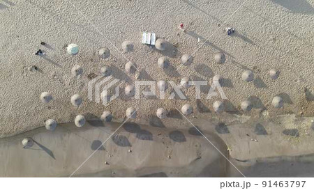 Umbrellas in empty sand beach Umbrellas in empty sand beach 91463797