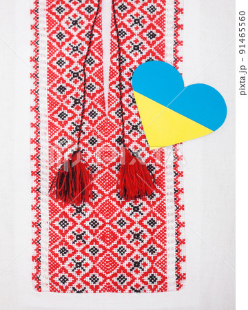 heart in the colors of the yellow and blue flag of Ukraine on the background of the national embroidered shirt 91465560