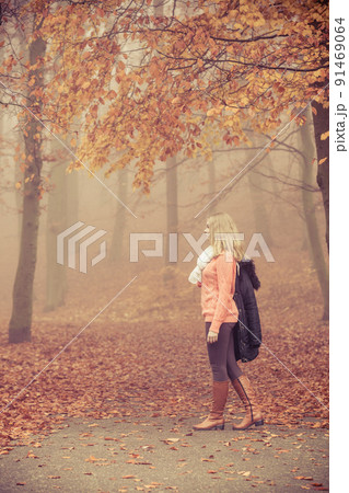 Fashion blonde woman with jacket in autumn park. Fashion blonde woman with jacket in autumn park. 91469064