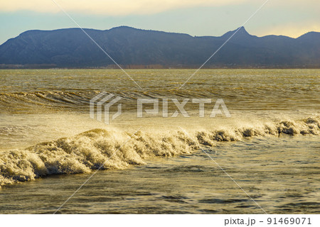 Sea waves forming white foam on sunny day. Sea waves forming white foam on sunny day. 91469071
